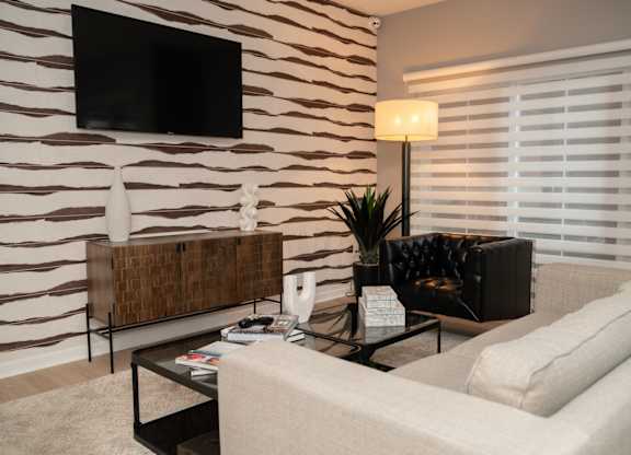 a living room with a couch and a coffee table at Monmouth Row Apartments, Newport, KY