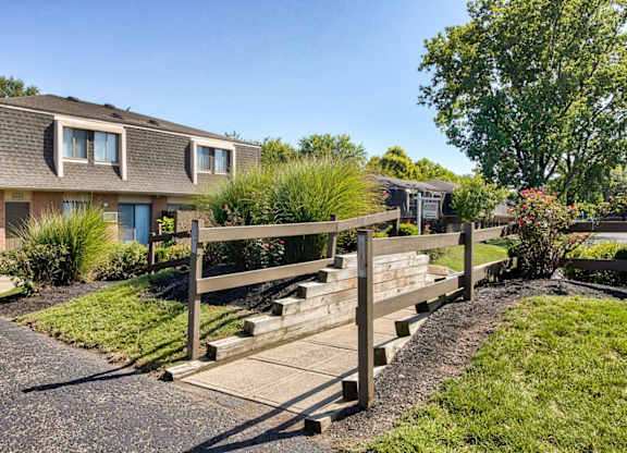 A residential area with houses and a wooden fence.