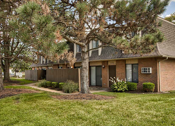 A tree in front of a house.