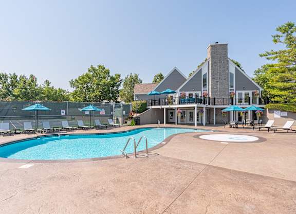 A large outdoor swimming pool with a building in the background.