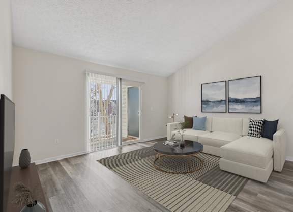 A living room with a white couch and a coffee table.