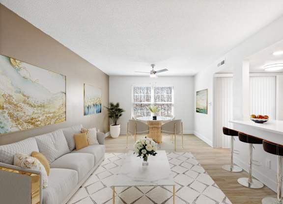 A living room with a white couch, a coffee table, and a painting on the wall.