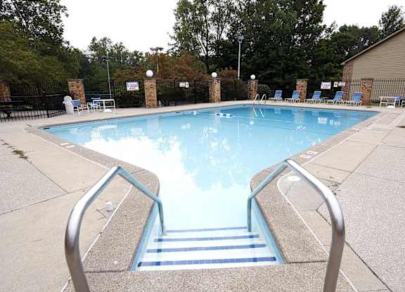 A pool with a metal staircase leading down to it.