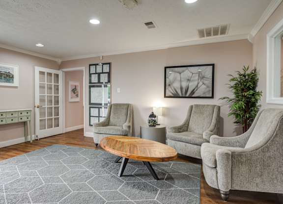 a living room with two chairs and a coffee table
