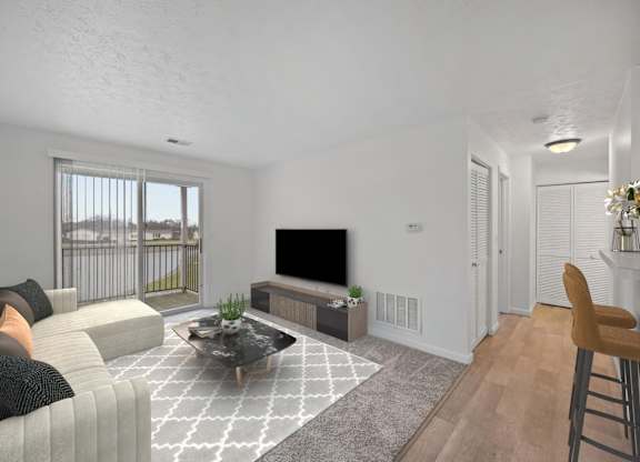 A living room with a grey sofa, a black coffee table, and a television.