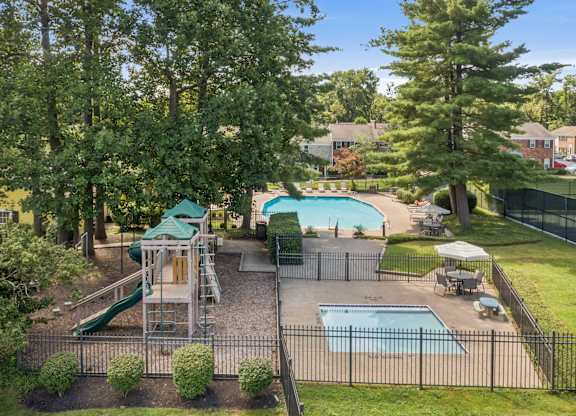 A backyard with a pool and slide.