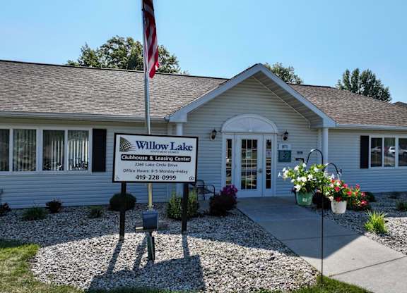 A building with a sign that says "Willow Lane" in front of it.