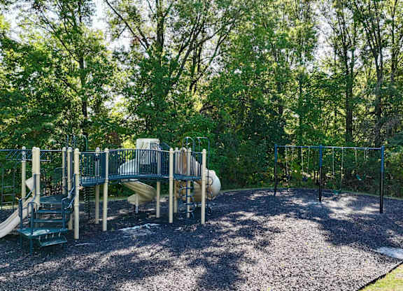 A playground with a slide, swings, and a climbing frame.