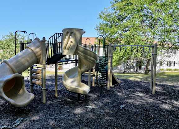 A playground with a slide and a climbing structure.