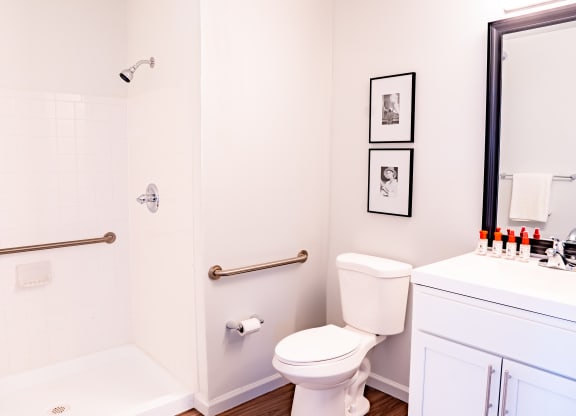 a bathroom with a white toilet next to a white bathtub