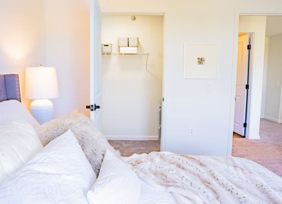 a bedroom with a bed and a lamp