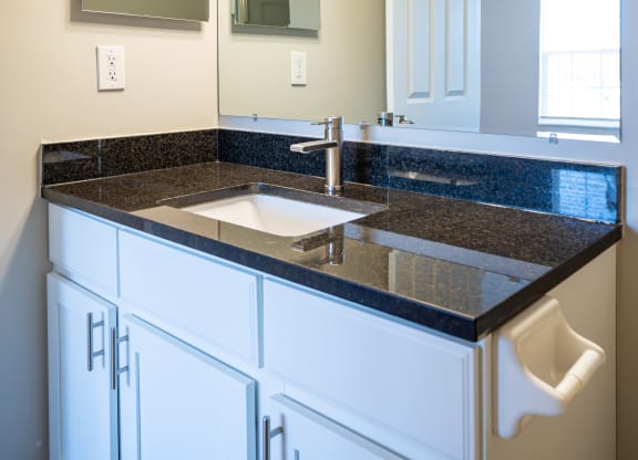 a bathroom with a sink and a mirror at Traditions at Slate Ridge, Reynoldsburg, OH