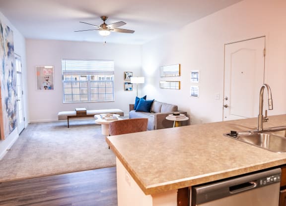 a kitchen with an island and a living room in the background  at Waterstone Landing, Perrysburg, 43551
