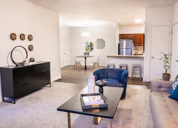 a living room with a couch coffee table and a kitchen in the background at Waterstone Landing, Perrysburg, OH