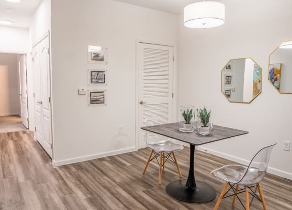 a dining area with a table and chairs and a hallway in the background  at Waterstone Landing, Ohio, 43551