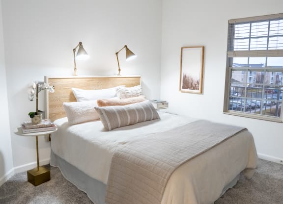 a bedroom with a bed and a window  at Waterstone Landing, Ohio