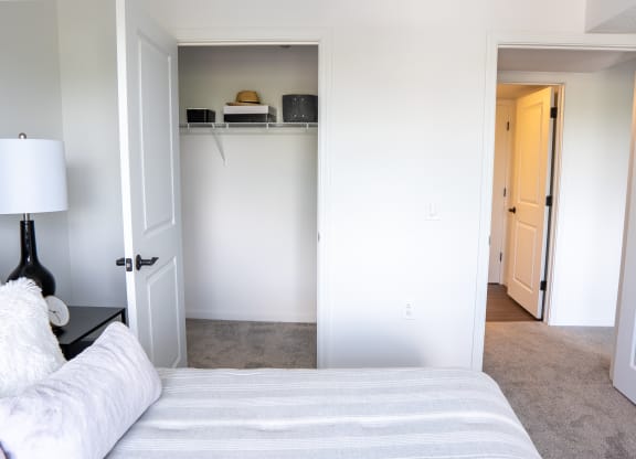 a bedroom with white walls and a white couch