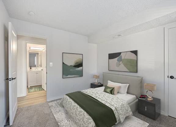 A bedroom with a bed, nightstand, and a painting on the wall.