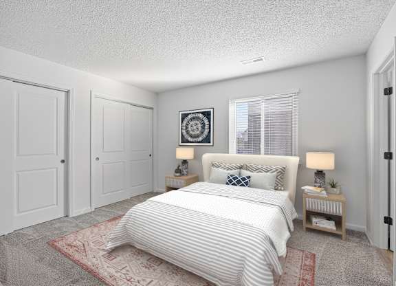 A bedroom with a large bed and two nightstands.