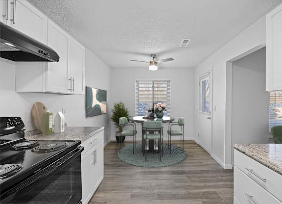 A kitchen with a table and chairs in the middle.