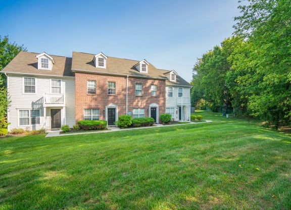 a large lawn in front of a brick house at Traditions at Slate Ridge, Ohio