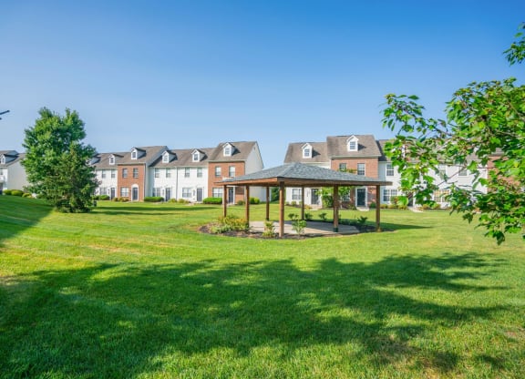 a park with a gazebo and houses in the background at Traditions at Slate Ridge, Reynoldsburg