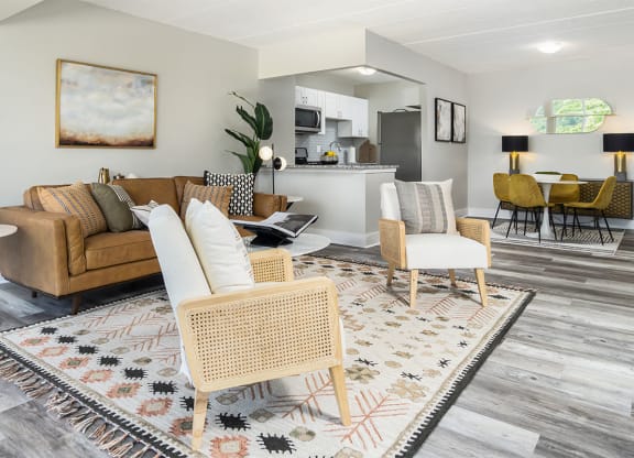 a living room with couches and chairs and a rug at The Heights Apartments, Cincinnati