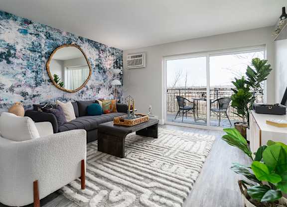 a living room with couches and a table at The Heights Apartments, Ohio