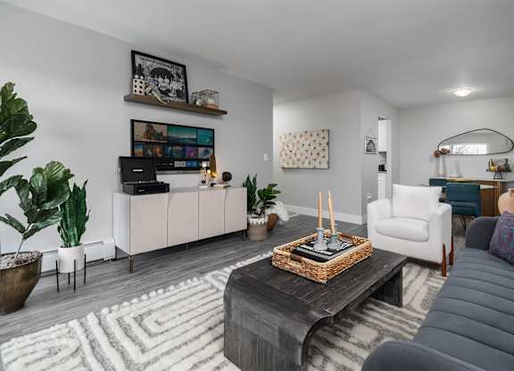 a living room with couches and chairs and a wall with the word rhymerce at The Heights Apartments, Cincinnati, OH