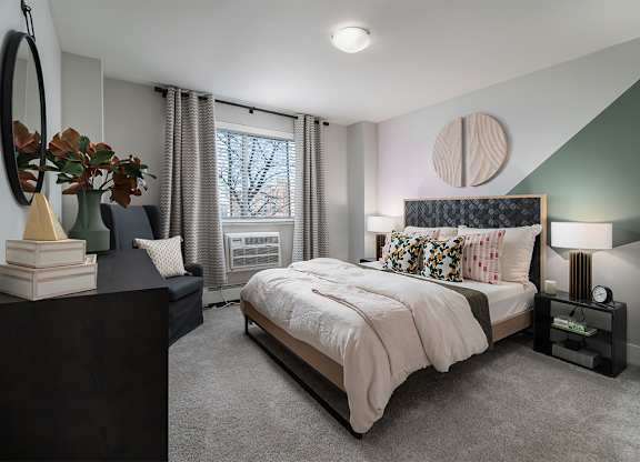 a bedroom with a bed and a window at The Heights Apartments, Cincinnati