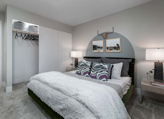 a bedroom with a bed and a closet at The Heights Apartments, Cincinnati, OH, 45220