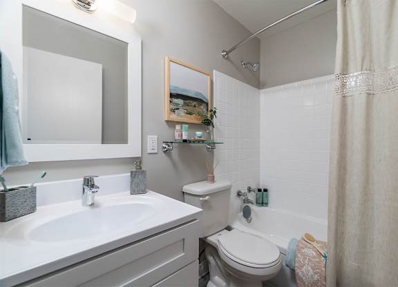 a bathroom with a sink toilet and a mirror at The Heights Apartments, Cincinnati, 45220