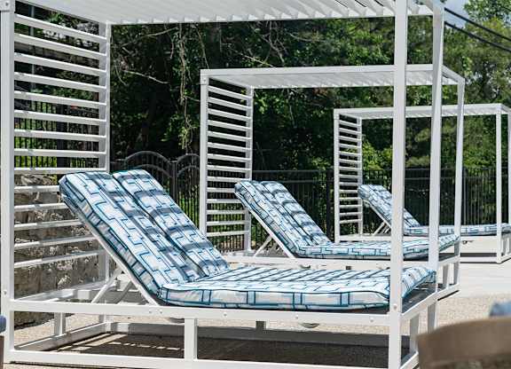 a group of lounge chairs on a patio at The Heights Apartments, Cincinnati