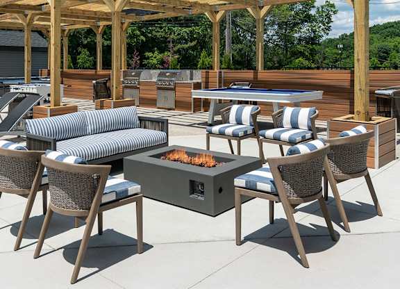 a patio with a fire pit and chairs and tables at The Heights Apartments, Ohio