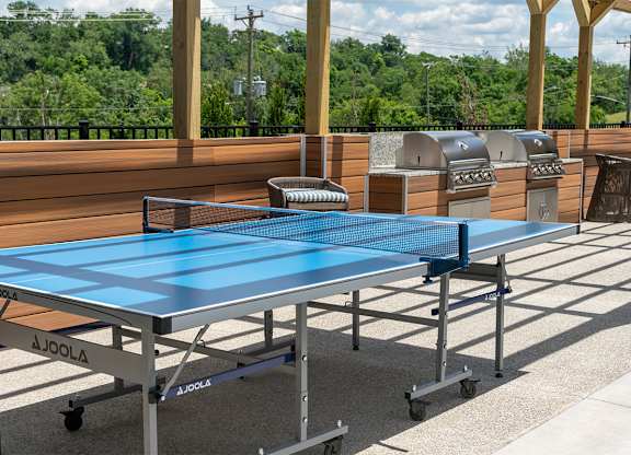 a blue ping pong table on a patio at The Heights Apartments, Cincinnati, Ohio