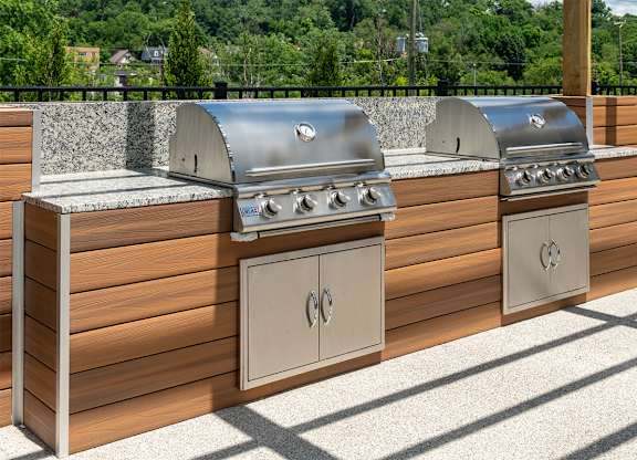two stainless steel barbecue grills next to each other on a patio at The Heights Apartments, Ohio, 45220