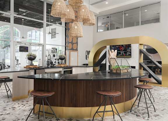 the lobby or reception area of a hotel with a bar and stools at The Heights Apartments, Cincinnati, Ohio