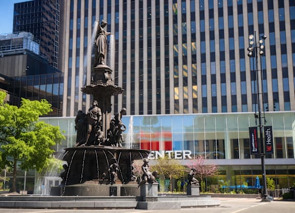 A fountain in front of a building with the word "CENTER" on it.