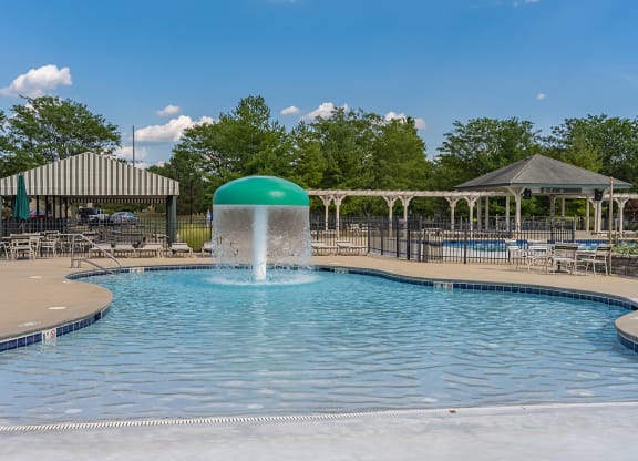 a pool with a water fountain in the middle of it at Four Bridges, Liberty Township, OH, 45044-8380