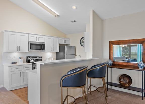 Kitchen with a bar with two chairs and a sink at Four Bridges, Liberty Township, OH, 45044-8380