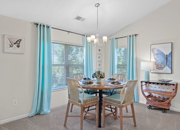 Dining room with a table and chairs and a chandelier at Four Bridges, Liberty Township, OH, 45044-8380