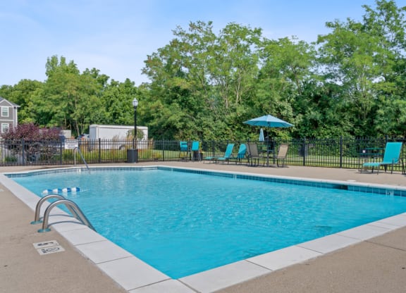 Swimming pool with blue chairs and a fence around it at Galbraith Pointe Apartments and Townhomes*, Ohio, 45231