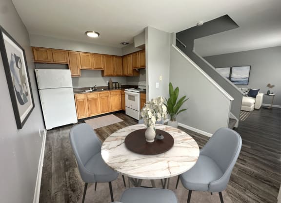 a kitchen and dining room with a table and chairs
