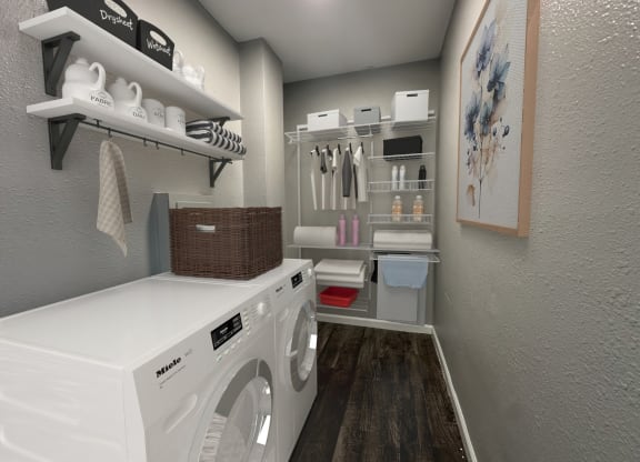 a laundry room with a washer and dryer and shelving and a closet