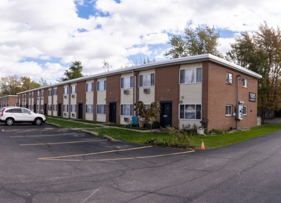 an empty parking lot in front of an apartment building
