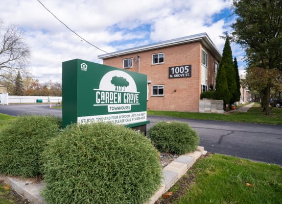 the sign for church hope apartments in front of a brick building
