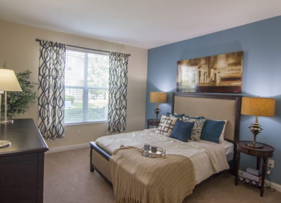 a bedroom with blue walls and a large window  at Grove City Summit, Ohio, 43123