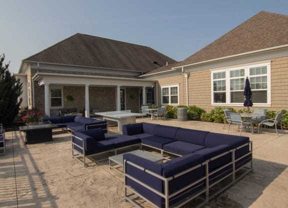 a large patio with blue couches and chairs  at Grove City Summit, Grove City, OH, 43123