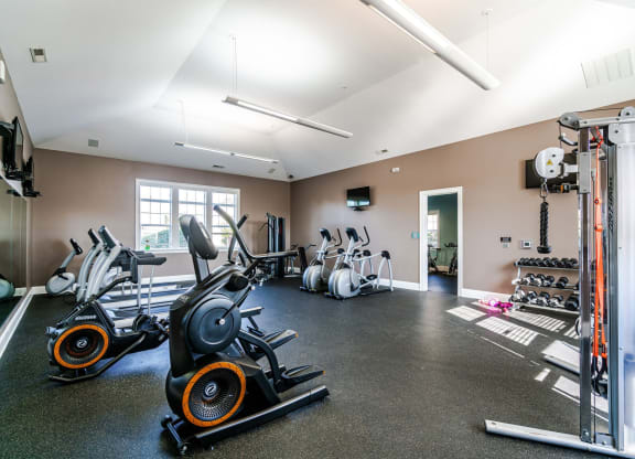 a gym with cardio equipment and weights on the floor at Grove City Summit Apartments, Grove City, OH
