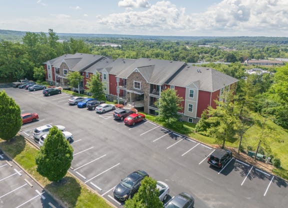 an aerial view of a parking lot and apartment buildings with cars parked  at Hilltop Apartments, Ohio, 45213-2638
